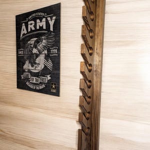 10-hat wall-mounted solid wood cap rack in dark walnut with staggered slots, styled on a light wood wall