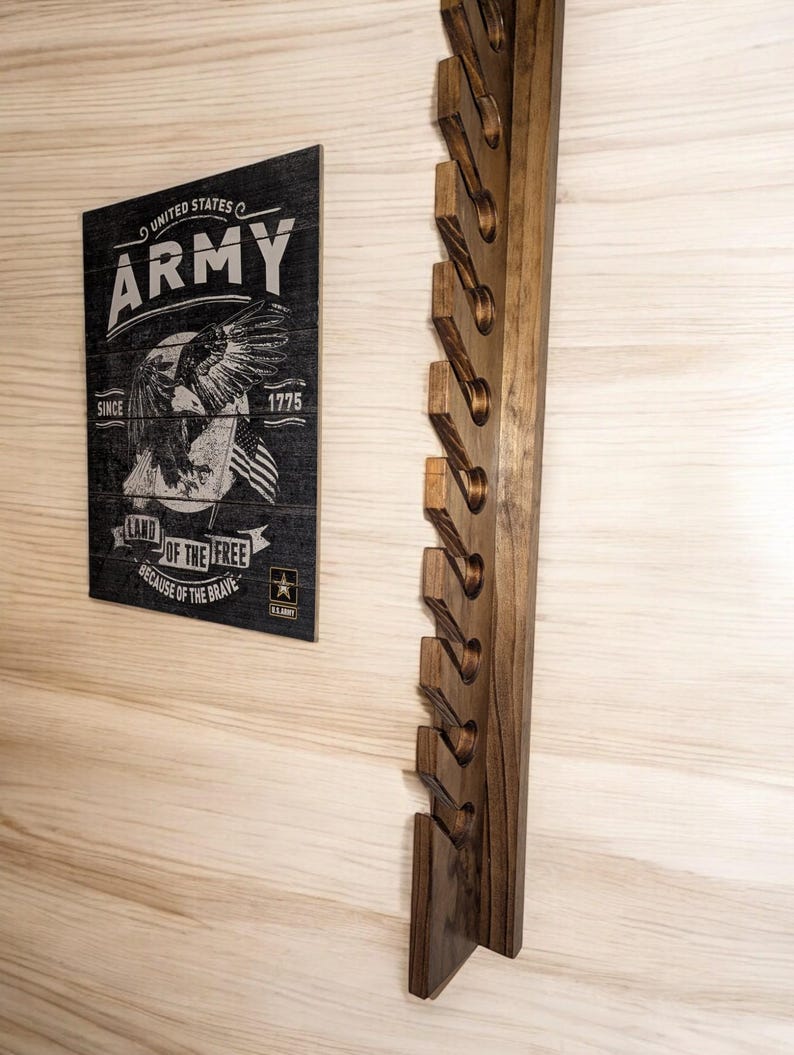 10-hat wall-mounted solid wood cap rack in dark walnut with staggered slots, styled on a light wood wall