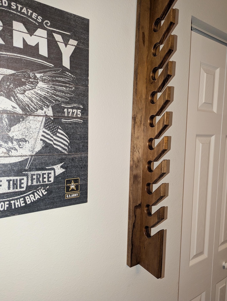 Side-angle view of the 10-hat wall rack highlighting the staggered slot design.