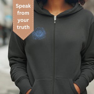 Dark gray unisex zip hoodie featuring throat chakra mandala design. Spiritual hoodie inspired by self-expression, authenticity and inner voice, created for mindful everyday wear.