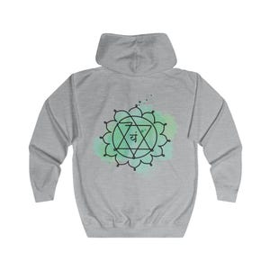 The back of the gray hoodie showcases a large, detailed Anahata chakra design, symbolizing love and balance. Perfect for yoga, meditation, or as a meaningful gift.