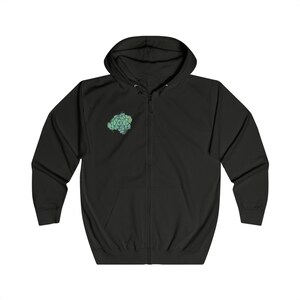 A sleek black full-zip hoodie with a subtle Anahata chakra emblem on the right chest. Ideal for layering and promoting emotional well-being.