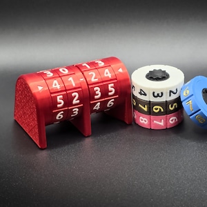May include: A red combination lock with white numbers and a blue and white combination lock. The red lock has a rectangular shape with a series of rotating number dials. The blue lock is a ring with numbers. The white and black lock is cylindrical.
