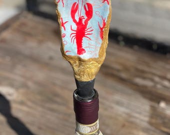Decoupaged oyster shell wine stopper