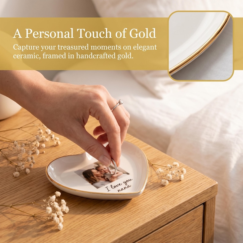 May include: A heart-shaped ceramic trinket dish with a gold rim, featuring a photo and the text "I love you nana." The dish is on a wooden nightstand. The image also includes the text "A Personal Touch of Gold."
