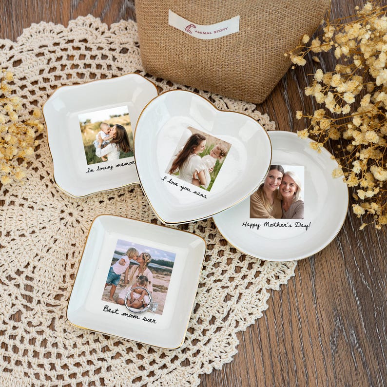 May include: Four white ceramic dishes with gold rims, each featuring a photograph and a handwritten message. The messages include "In loving memory," "I love you nana," "Happy Mother's Day!," and "Best mom ever."