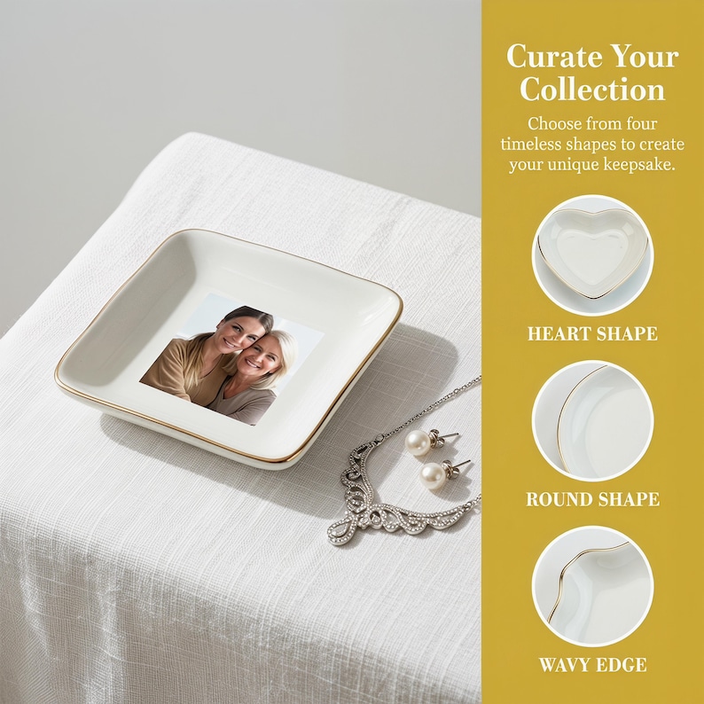 May include: A white square trinket dish with a gold rim, featuring a photo of two women. A silver necklace with pearls and matching earrings are next to the dish. Text on the right says "Curate Your Collection".