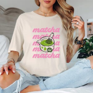 Natural matcha club shirt with playful pink matcha design and green tea illustration, cute cafe aesthetic tee for matcha lovers.