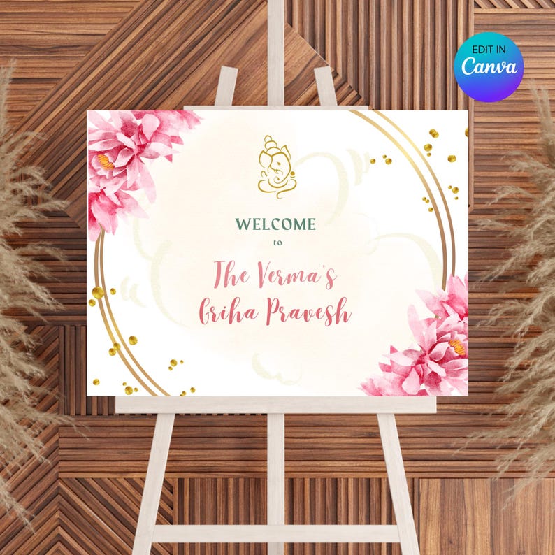 May include: Welcome sign with a white background, gold circles, and pink flowers. The text reads "Welcome to The Verma's Griha Pravesh".