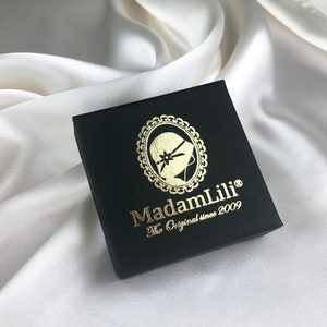 May include: A black box with a gold logo that says "MadamLili" and "The Original since 2009".