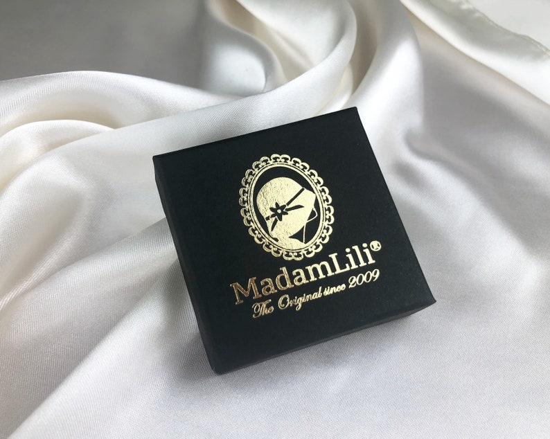 May include: A black box with a gold logo that says "MadamLili" and "The Original since 2009".
