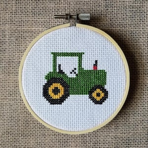 May include: A green tractor cross-stitch embroidery in a round wooden hoop.