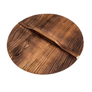May include: A round wooden lid with a dark brown finish and a wooden handle. The lid has a natural wood grain pattern.