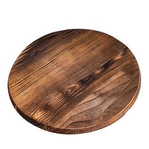 May include: A round wooden serving tray with a dark brown wood grain finish. The tray is made of natural wood and has a rustic look.