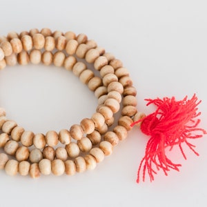 Brown Carved Bone 108  Beads, 8-9mm round, Red tassel   15 Inch Strand  -BN230