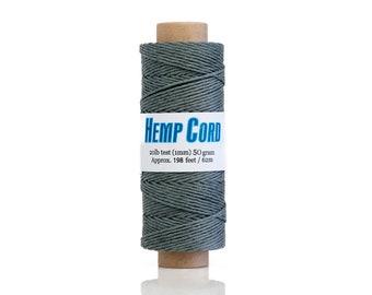 May include: A spool of gray hemp cord with a label that reads "HEMP CORD". The label also states "20lb test (1mm) 50 gram Approx. 198 feet / 62m". The cord is wrapped around a cardboard tube.