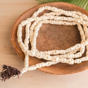 Cream Bone Skull Beads, 108 beads with  Red tassel,   26 Inch Strand  -B3331