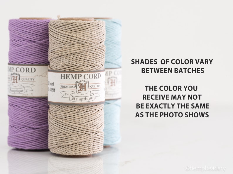 May include: Three spools of hemp cord in lavender, natural, and light blue. The spools are labeled "Hemp Cord" with the brand name "Hemptique". The text "Shades of color vary between batches" and "The color you receive may not be exactly the same as the photo shows" is printed below the spools.