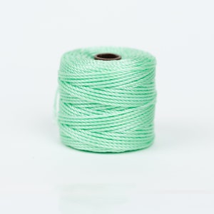 May include: A spool of light green cord.