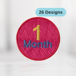 May include: A red circle with a pink and white wave pattern. The number 1 is embroidered in yellow and the word "Month" is embroidered in blue. The text "26 Designs" is in a blue box above the circle.