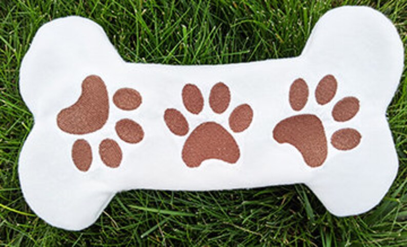 DIY dog bone toy embroidery design with paw prints.