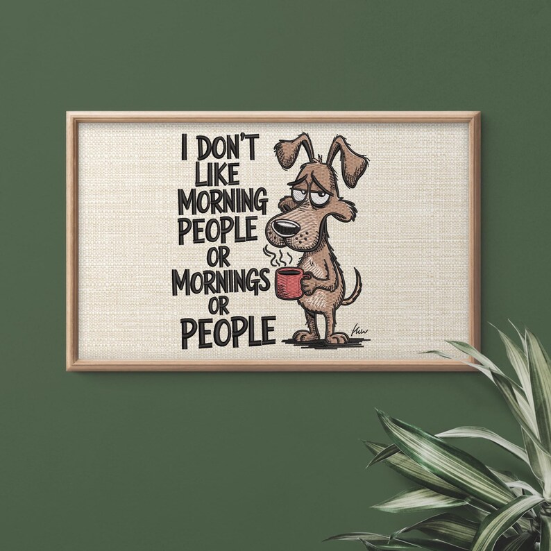 May include: A framed print featuring a cartoon dog holding a red mug, with the text "I DON'T LIKE MORNING PEOPLE OR MORNINGS OR PEOPLE." The dog has a sleepy expression. The frame is light brown, and the background is a textured beige.