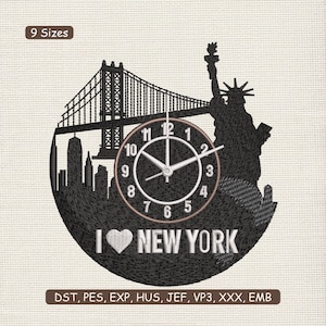 May include: Black embroidered wall clock featuring a New York City design. The clock includes the Brooklyn Bridge, the Statue of Liberty, and the phrase "I ❤️ NEW YORK." The clock face has white numbers and hands.
