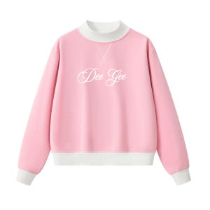 May include: A light pink long-sleeve sweatshirt featuring a white mock neck collar, white sleeve cuffs, and a white hem. The center of the chest displays the text Dee Gee in a white cursive script font, with a white stitched X detail below the collar.
