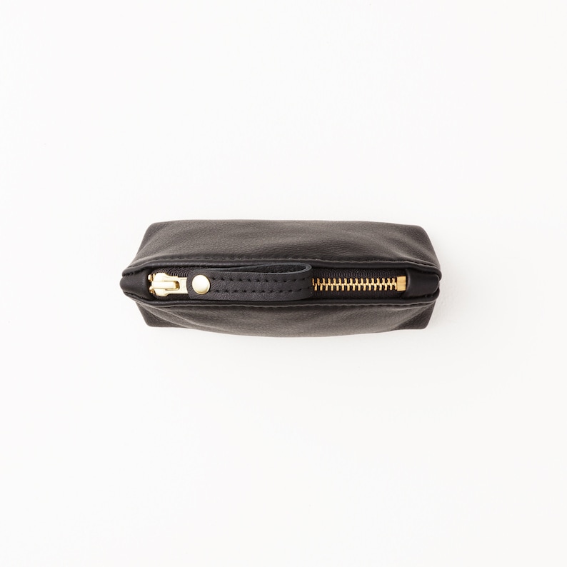 Top zipper view of small leather clutch.