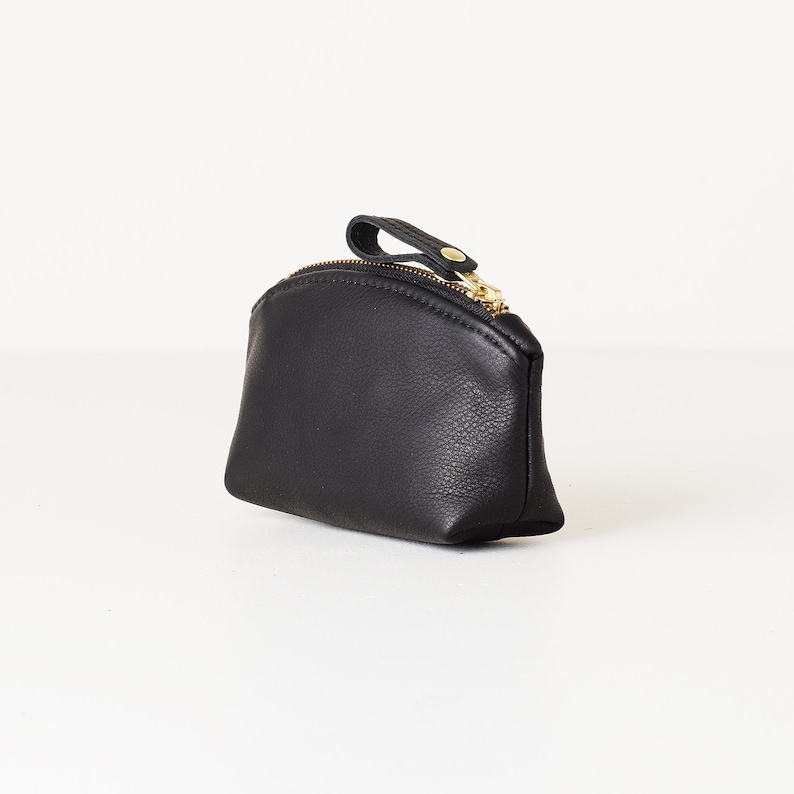 Small leather clutch on tabletop.