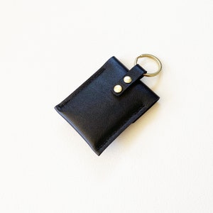 Reverse side of leather keychain snap closure credit card wallet.