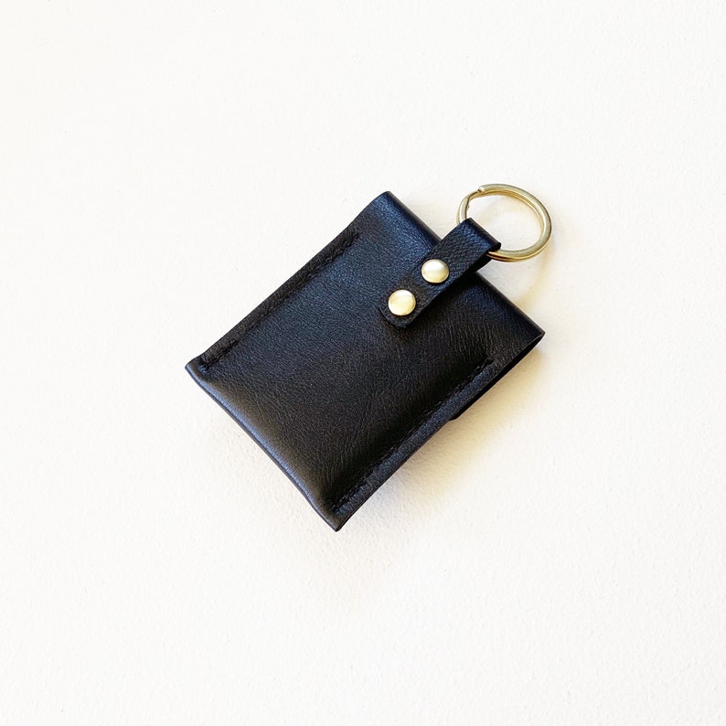 Reverse side of leather keychain snap closure credit card wallet.