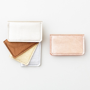 Set of five metallic leather credit card wallets in a variety of colors.