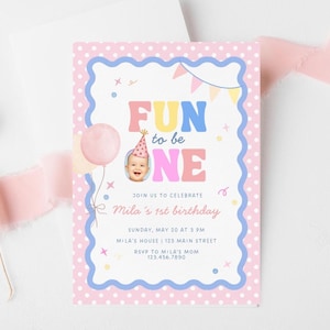 Może przedstawiać: R&oacute;żowe i niebieskie zaproszenie urodzinowe z napisem "FUN to be ONE". Zaproszenie zawiera zdjęcie dziecka w czapeczce urodzinowej, r&oacute;żowy balon i napis "Mila's 1st birthday".