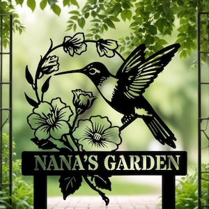 May include: Black metal garden sign featuring a hummingbird silhouette, flowers, and the text "NANA'S GARDEN".