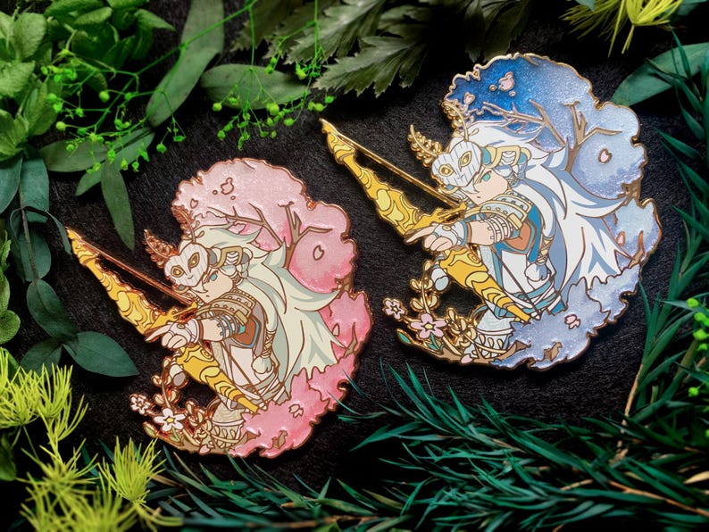 May include: Two enamel pins featuring a character with a bow and arrow. One pin has a pink cherry blossom design, the other a blue winter theme. Both pins have gold accents and intricate details, perfect for collectors.