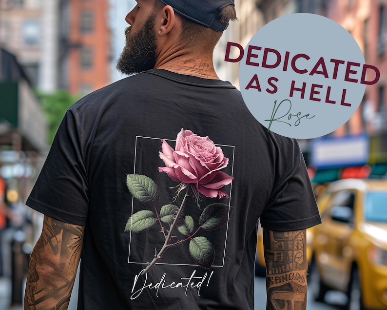 May include: A black t-shirt with a pink rose graphic and the text "Dedicated!" printed on the back. The text "Dedicated as Hell Rose" is printed in a circle on the front of the shirt.