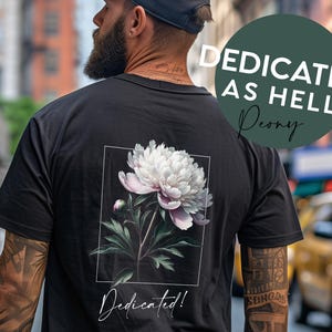 May include: Black t-shirt with a white peony flower graphic and the text "Dedicated!" printed on the back. The text "Dedicated as Hell Peony" is printed on a green circle.