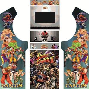 May include: Arcade cabinet control panel decal featuring a colourful illustration of characters from the Street Fighter II video game. The decal includes the game's title, "Street Fighter II", and the Capcom logo.