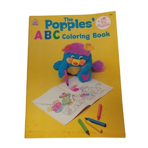 May include: A vintage "The Popples' ABC Coloring Book" with a blue and purple Popples plush toy. The coloring book is open to a partially colored page with several colored markers scattered around. The cover is yellow with the title in colorful letters.