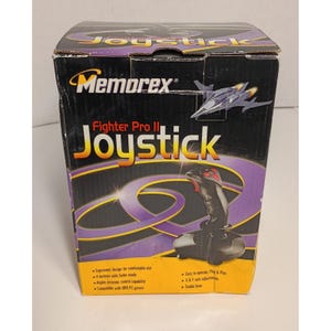 May include: A black cardboard box for a Memorex Fighter Pro II Joystick. The packaging features a graphic of a fighter jet, the product name in yellow and white text, and a black joystick. The lower section includes yellow text details.