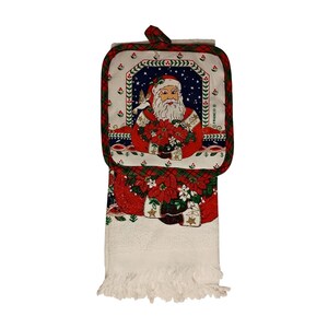 May include: A Christmas-themed kitchen set featuring a pot holder and a towel. The pot holder has a Santa Claus design with a red and white plaid border. The towel has a white fringe and a matching Santa and poinsettia design.