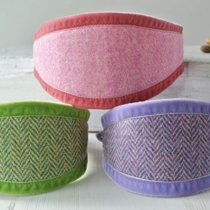May include: Three dog collars with different patterns and colors. The collars are made of tweed fabric with a velvet trim. The collars are pink, green, and purple.