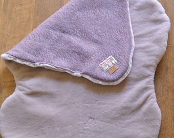 Organic luxury sheepskin and purple herringbone Harris Tweed blanket.