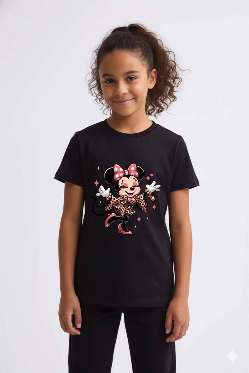 May include: Black t-shirt featuring a cartoon Minnie Mouse design. Minnie Mouse is wearing a leopard print jacket and bow, with pink accents. The design includes stars and sparkles. The shirt is worn by a young person.