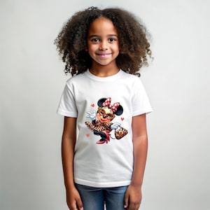 May include: White t-shirt featuring a cartoon Minnie Mouse in a leopard print outfit, sunglasses, and a red bow. The design includes small pink hearts. The shirt is worn by a young girl.