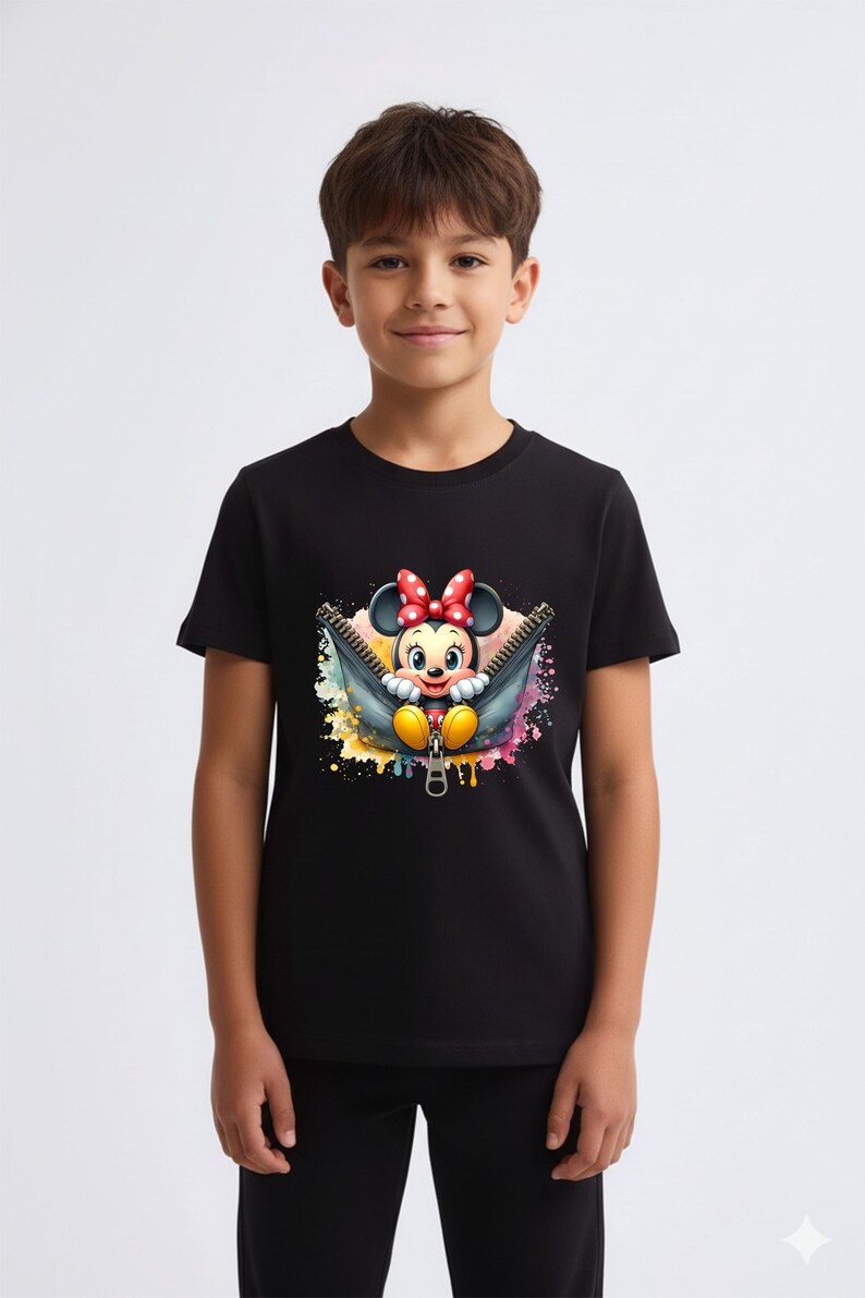 May include: Black t-shirt featuring a colorful graphic of Minnie Mouse emerging from a zipper. Minnie Mouse is wearing a red bow and yellow shoes. The background has colorful paint splatters. The shirt is worn by a young person.