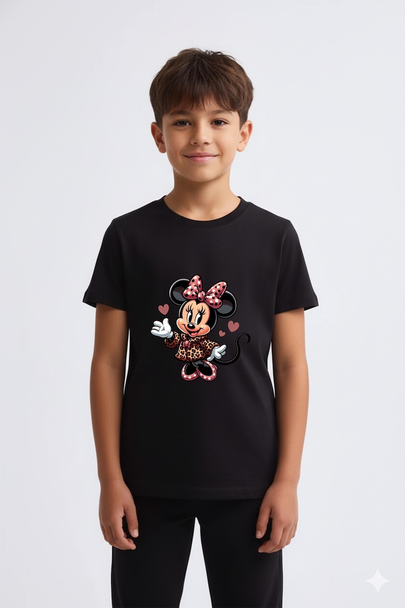 May include: Black t-shirt featuring a Minnie Mouse graphic. Minnie is wearing a bow, dress, and shoes with a pink and red heart pattern. The shirt is short-sleeved and has a crew neck.