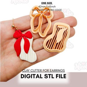 May include: A pair of Christmas-themed earrings with a red bow and white stocking design. Next to the earrings are two clay cutters, one bow-shaped and one stocking-shaped. The text on the image reads "ONE SIZE 42mm/1.65inch 0.4 SHARP CUTTING EDGE CLAY CUTTER FOR EARRINGS DIGITAL STL FILE."