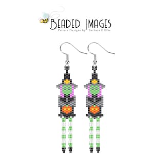 May include: A pair of beaded earrings featuring a witch with a black hat, green and purple dress, and a pumpkin. The earrings have a black and white fringe.